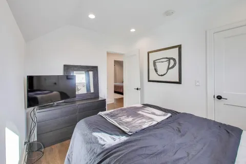 a bedroom with a bed and a flat screen tv