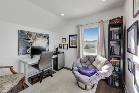 a work room with furniture and a book shelf