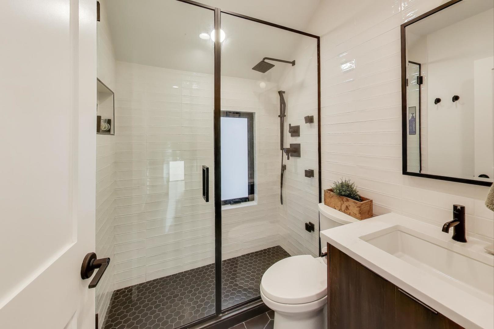 4438 North Spaulding Avenue Chicago, IL 60625 - Photo 24 of 40 a bathroom with a sink toilet vanity and shower