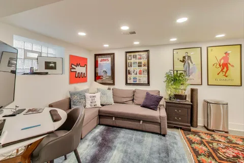 a bathroom with stainless steel appliances granite countertop a rug and a shower