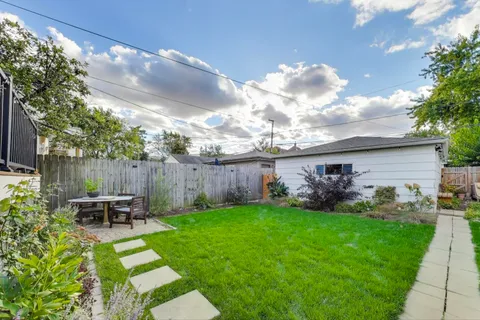 a front view of a house with garden and patio