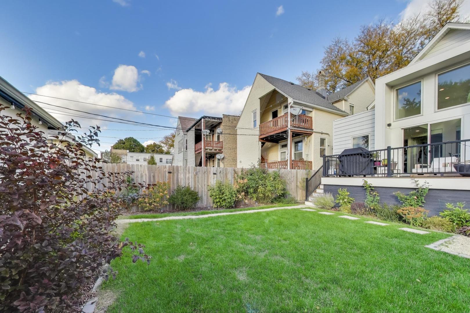 4438 North Spaulding Avenue Chicago, IL 60625 - Photo 36 of 40 a front view of a house with garden and patio