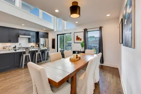 a large kitchen with a table and chairs