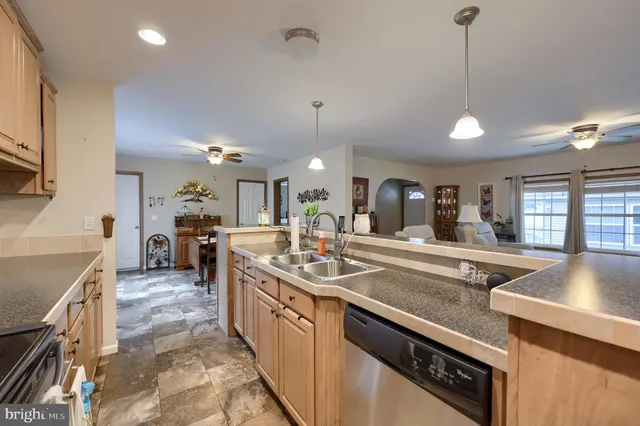 a kitchen with sink stove and cabinets