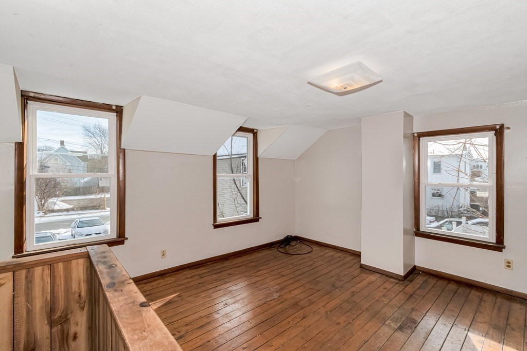12 Cherry Street Westfield, MA 01085 - Photo 7 of 11 a view of an empty room with window and wooden floor
