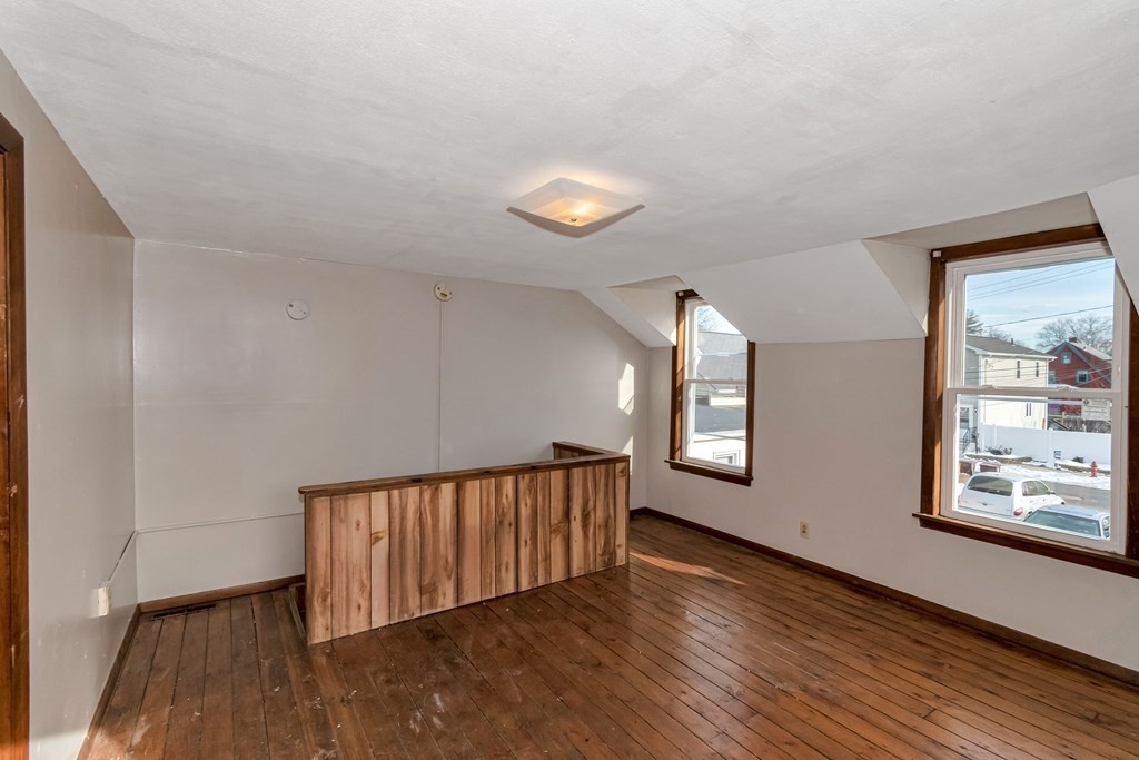 12 Cherry Street Westfield, MA 01085 - Photo 9 of 11 a view of an empty room with wooden floor and a window