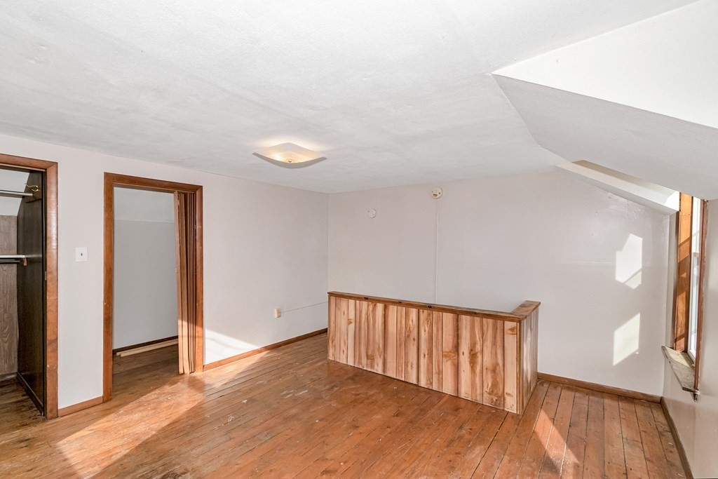 12 Cherry Street Westfield, MA 01085 - Photo 10 of 11 a view of an empty room with wooden floor and a window