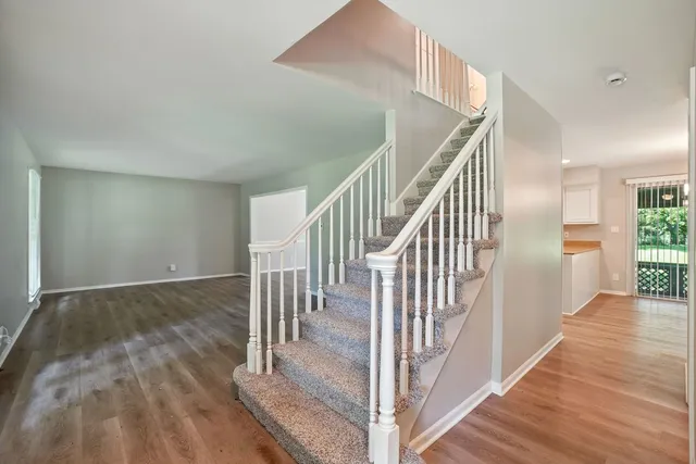 a view of entryway and hall with wooden floor