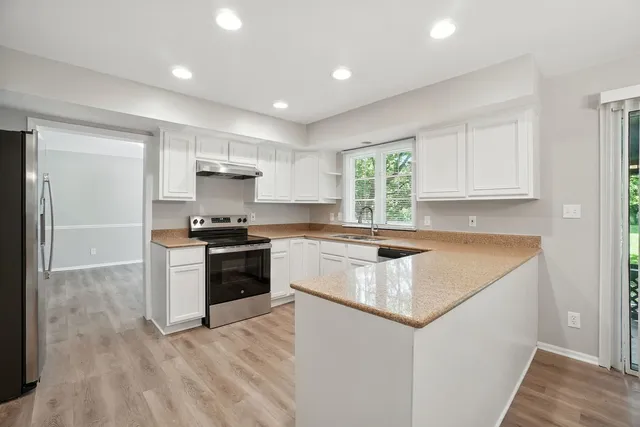a kitchen with a stove a sink and a refrigerator