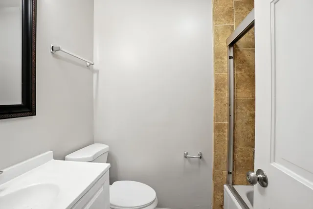 a white toilet sitting next to a bathroom sink