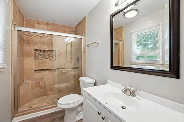 a bathroom with a sink toilet and shower