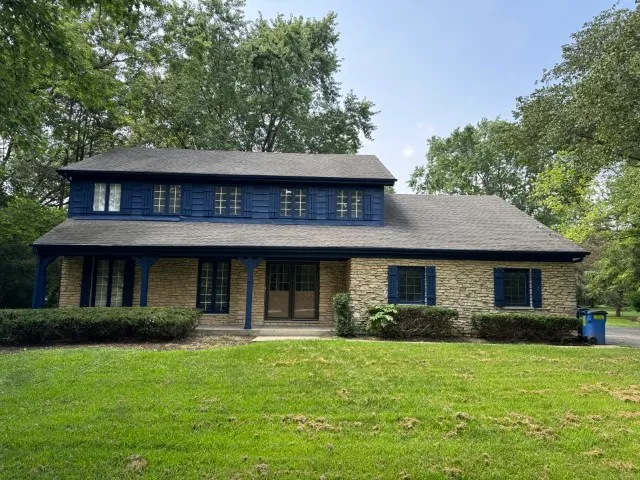 a front view of a house with a garden