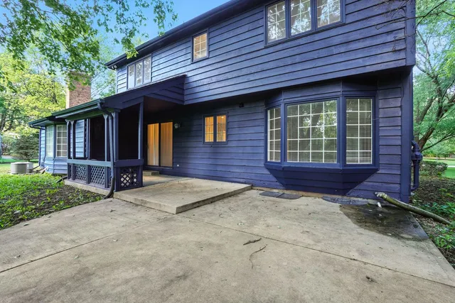 a view of house with backyard space and balcony