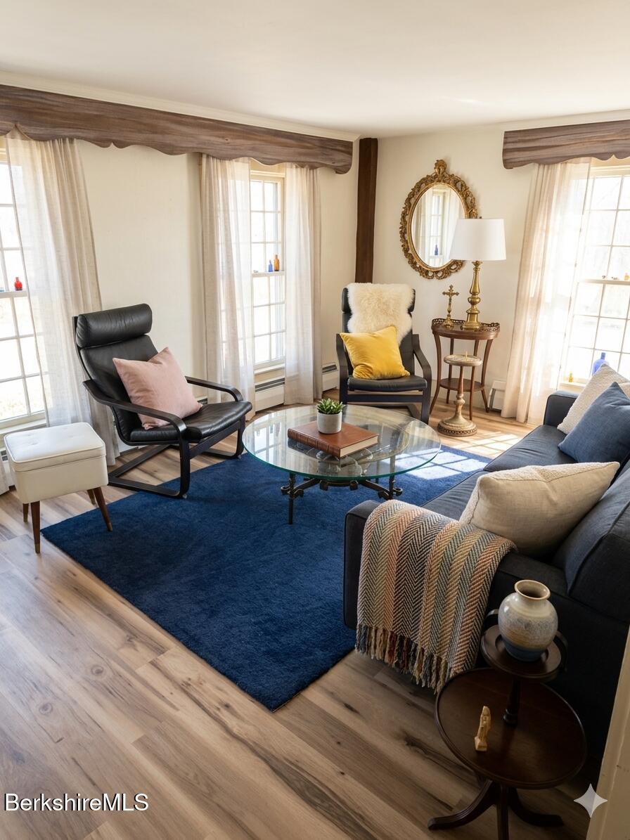 27 North Main Road Otis, MA 01253 - Photo 8 of 24 a living room with furniture a fireplace and a large window