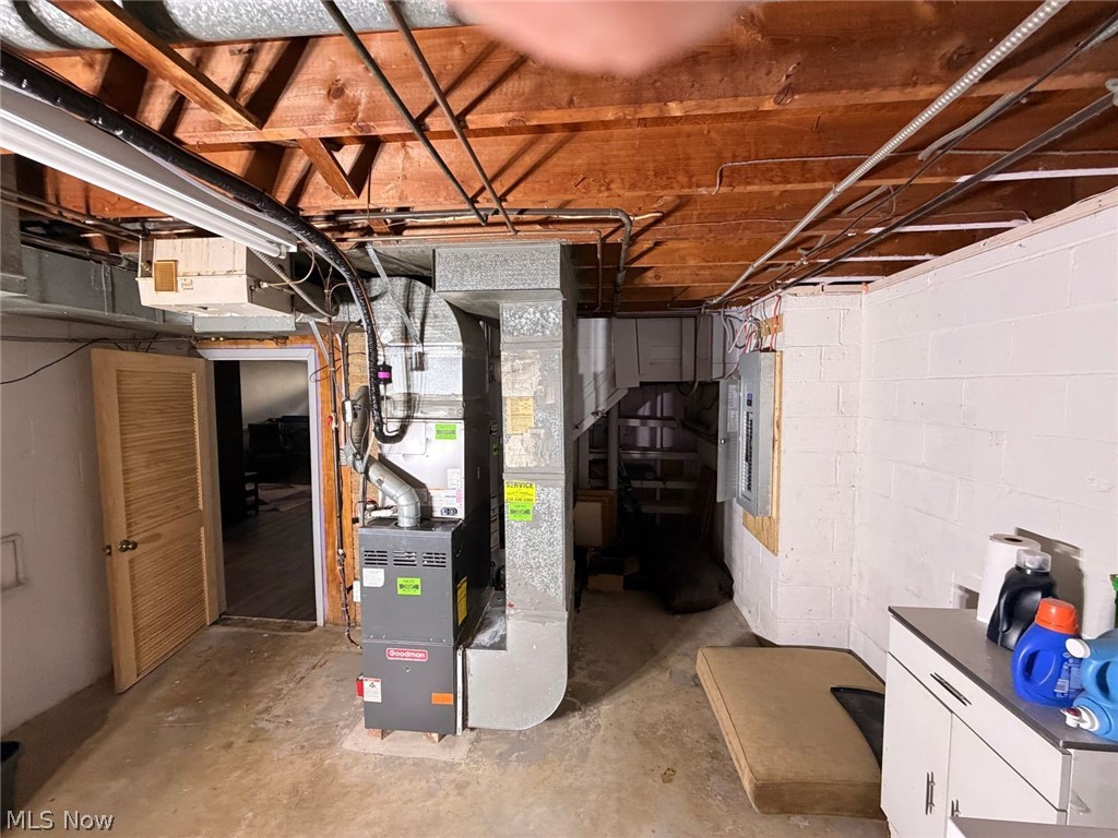 7239 Oakwood Road Parma, OH 44130 - Photo 14 of 14 Exposed wood joists, utility sink with countertop, and white block walls