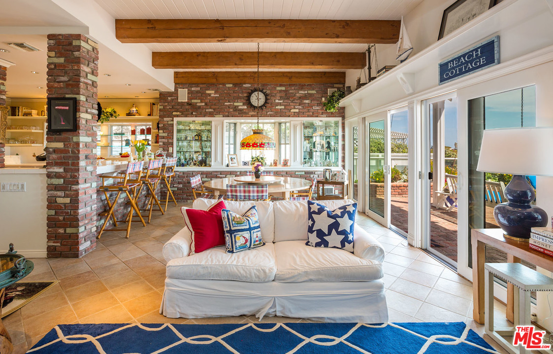 31026 Broad Beach Road Malibu, CA 90265 - Photo 14 of 40 a living room with furniture and a floor to ceiling window
