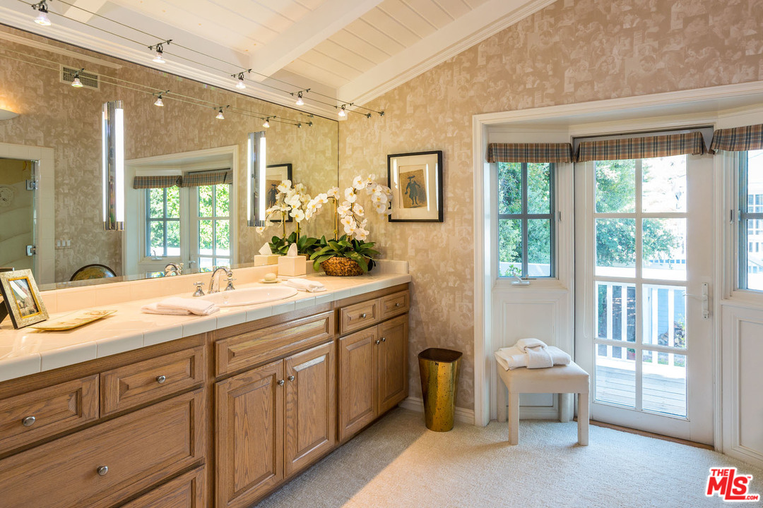 31026 Broad Beach Road Malibu, CA 90265 - Photo 27 of 40 a spacious bathroom with a granite countertop sink mirror and a bathtub