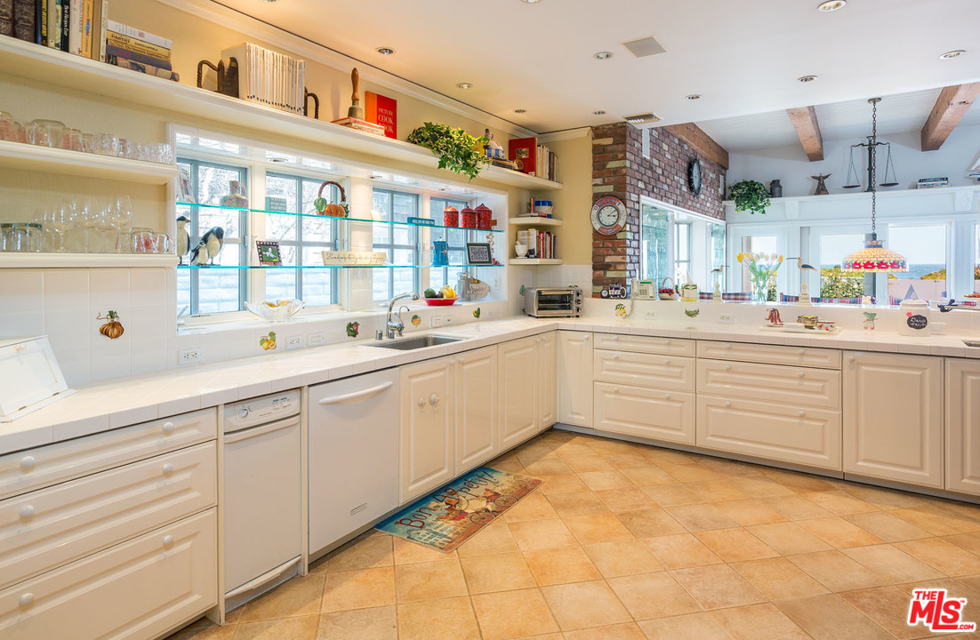 31026 Broad Beach Road Malibu, CA 90265 - Photo 28 of 40 a kitchen with a sink and cabinets