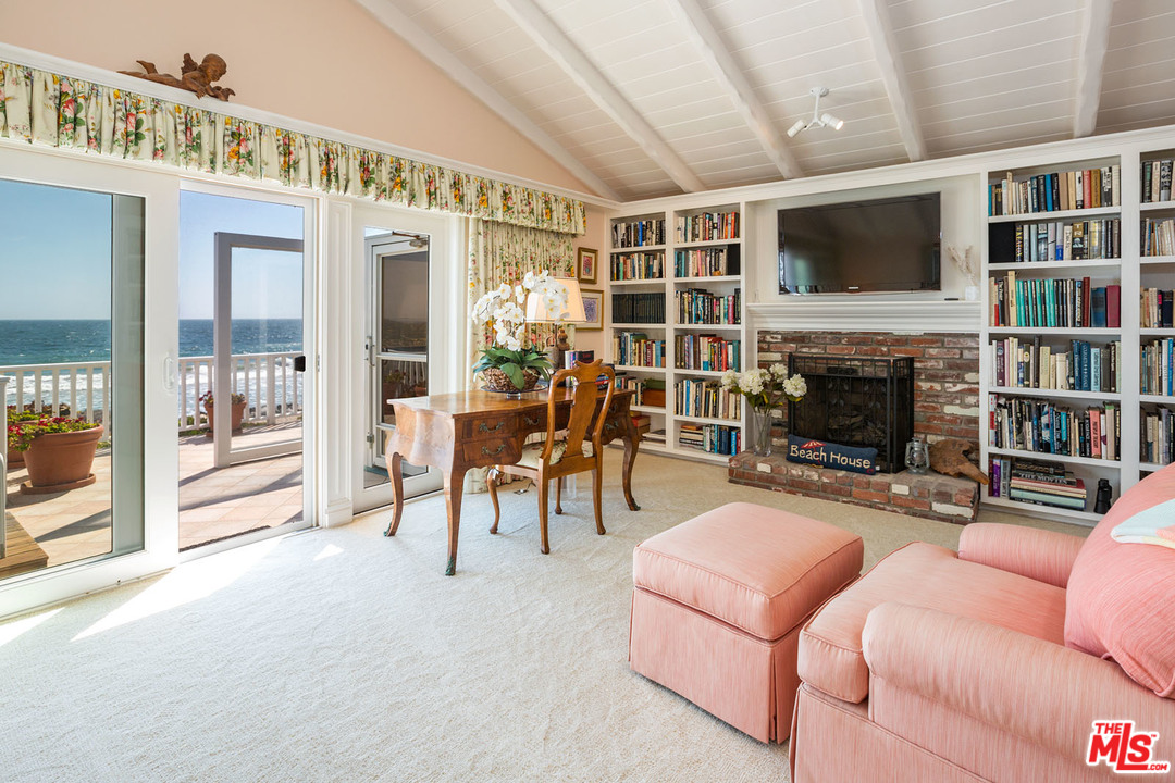 31026 Broad Beach Road Malibu, CA 90265 - Photo 29 of 40 a living room with furniture a fireplace and a flat screen tv