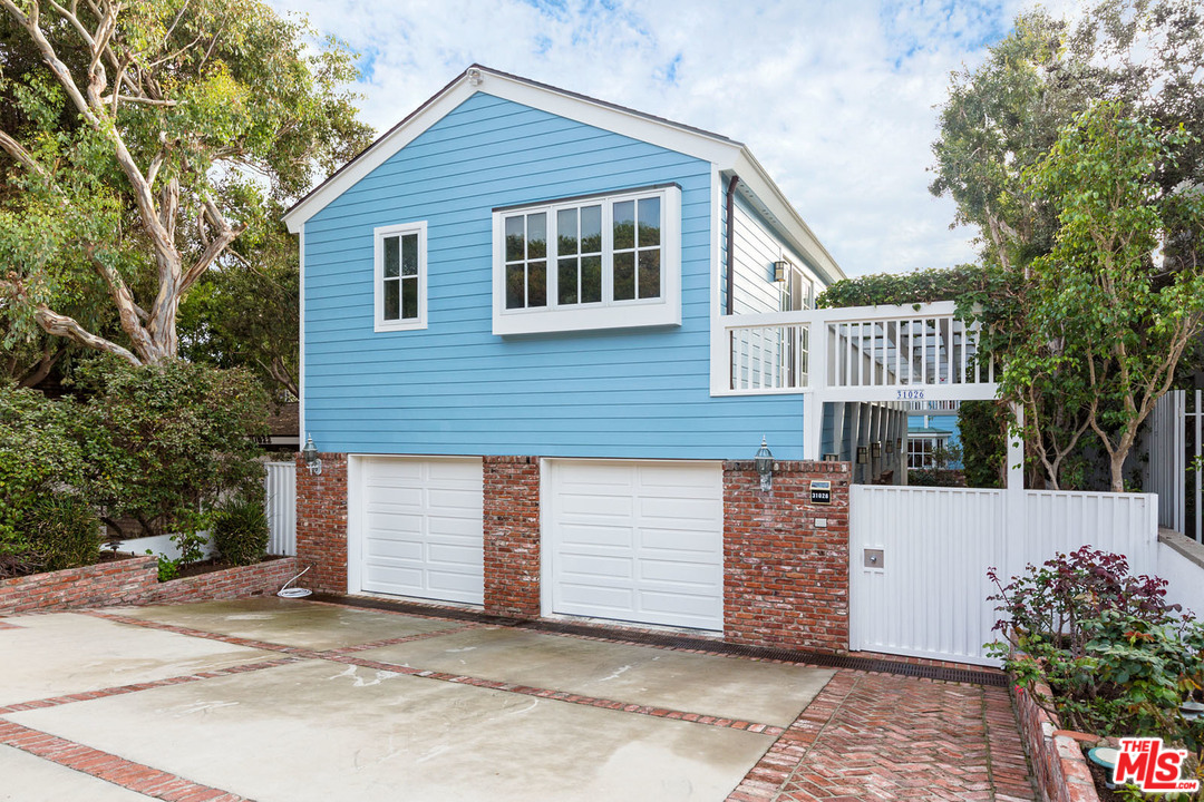 31026 Broad Beach Road Malibu, CA 90265 - Photo 32 of 40 a front view of a house with a garden