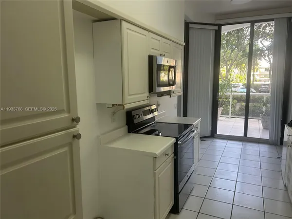 a kitchen with a stove top oven and sink