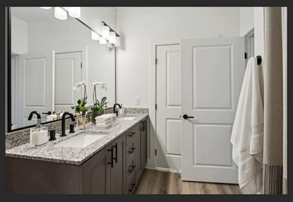 4000 Anserra Trail, Unit C Katy, TX 77494 - Photo 8 of 10 a bathroom with a granite countertop sink and a mirror