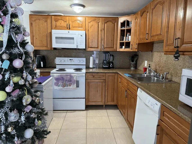 a bedroom with bed tv and window