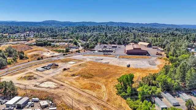 a view of a terrace with furniture and a garden