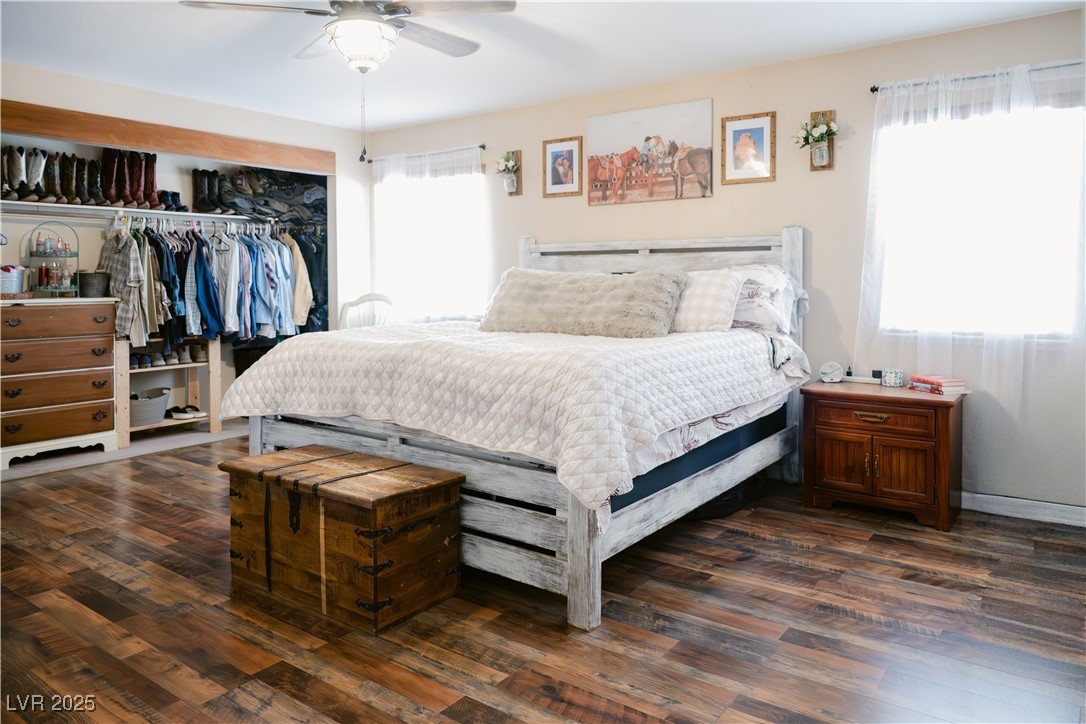 1515 Darlene Way Boulder City, NV 89005 - Photo 15 of 22 Bedroom with multiple windows, dark wood-style flooring, a closet, and a ceiling fan