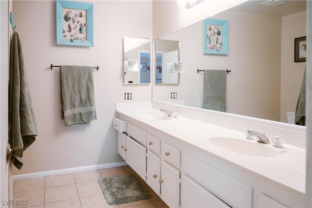 1515 Darlene Way Boulder City, NV 89005 - Photo 16 of 22 Bathroom featuring double vanity and light tile patterned flooring