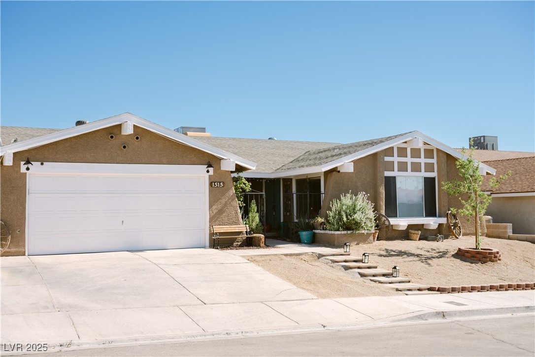 1515 Darlene Way Boulder City, NV 89005 - Photo 3 of 22 Single story home featuring stucco siding, driveway, and a garage