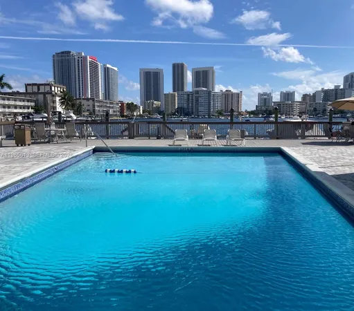 a view of a swimming pool with outdoor seating