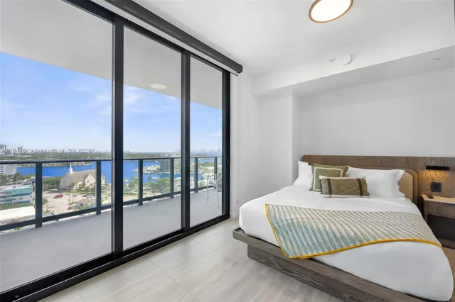 a bedroom with a large bed and a large window