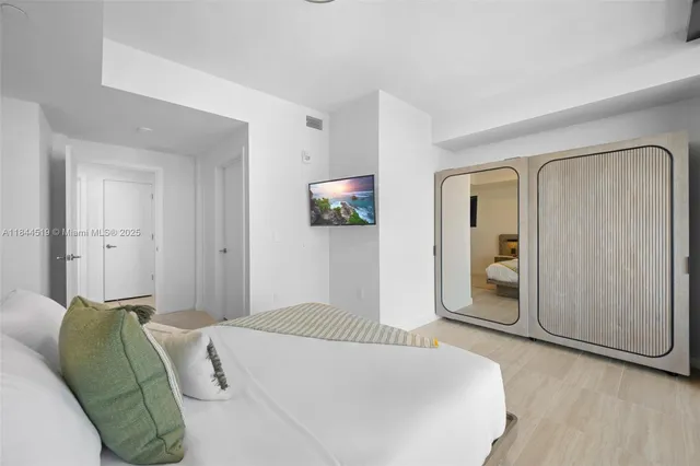 a bedroom with a bed and a mirror