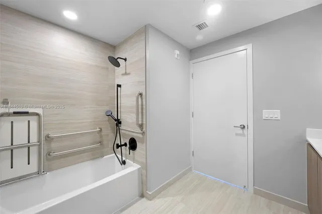 a bathroom with a bathtub and a shower
