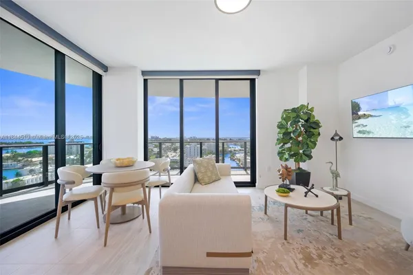 a living room with furniture and a potted plant