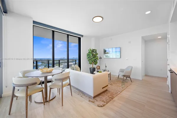 a living room with furniture and large windows
