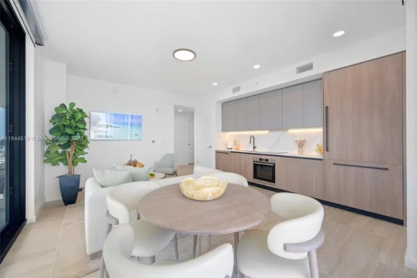 a kitchen with a table and chairs in it
