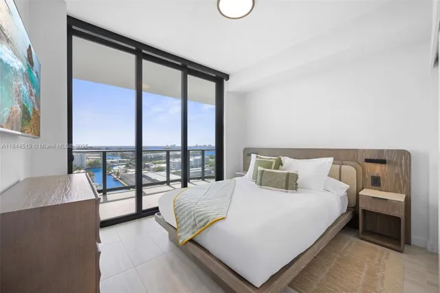 a bedroom with a bed and a night stand