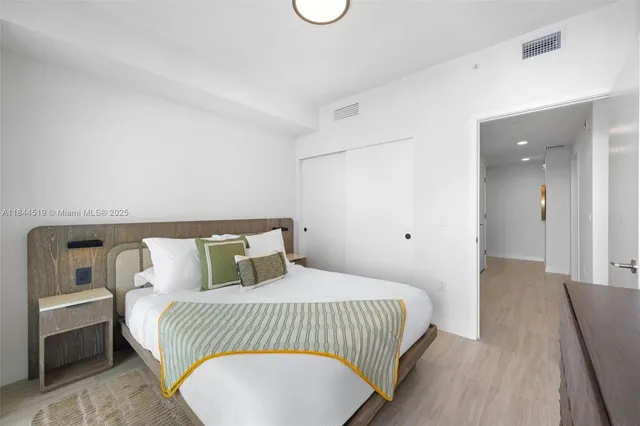 a bedroom with a bed and a night stand