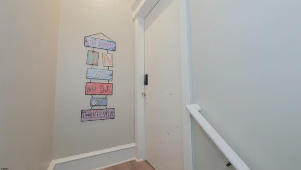 a very nice looking dining room with kitchen island furniture a large window and a refrigerator