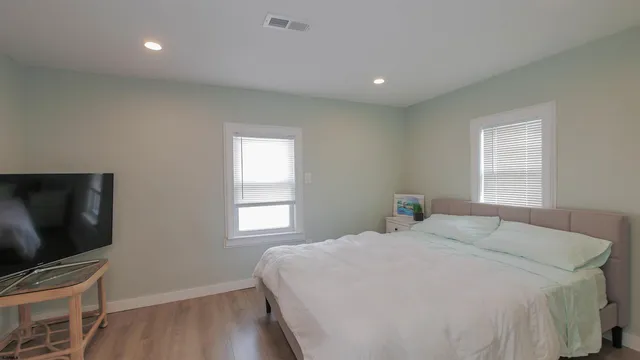 a bedroom with a bed and a flat screen tv