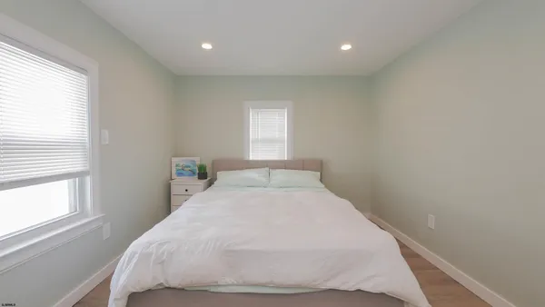 a bedroom with a bed and a large window