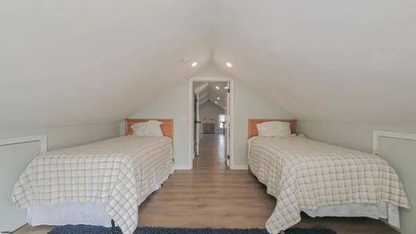 a bedroom with bed and a night stand