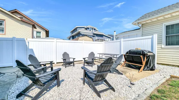 a view of a patio with table and chairs potted plants with wooden fence