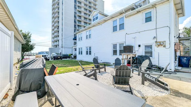 a view of a roof deck with furniture