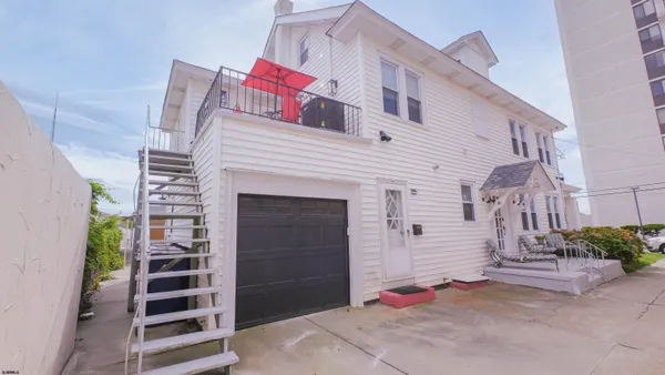 a view of a patio with table and chairs and potted plants