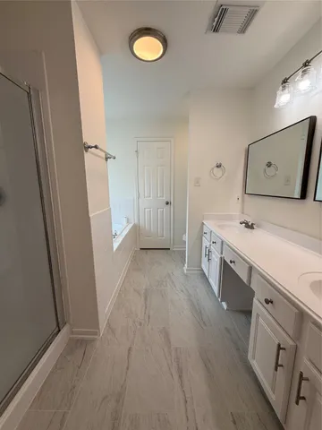 a large bathroom with a double vanity sink and a mirror