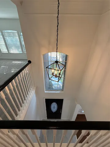 an empty room with windows and ceiling fan