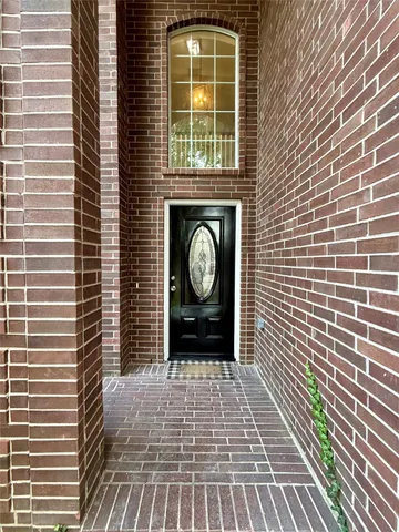 a view of a door with a door and a rug